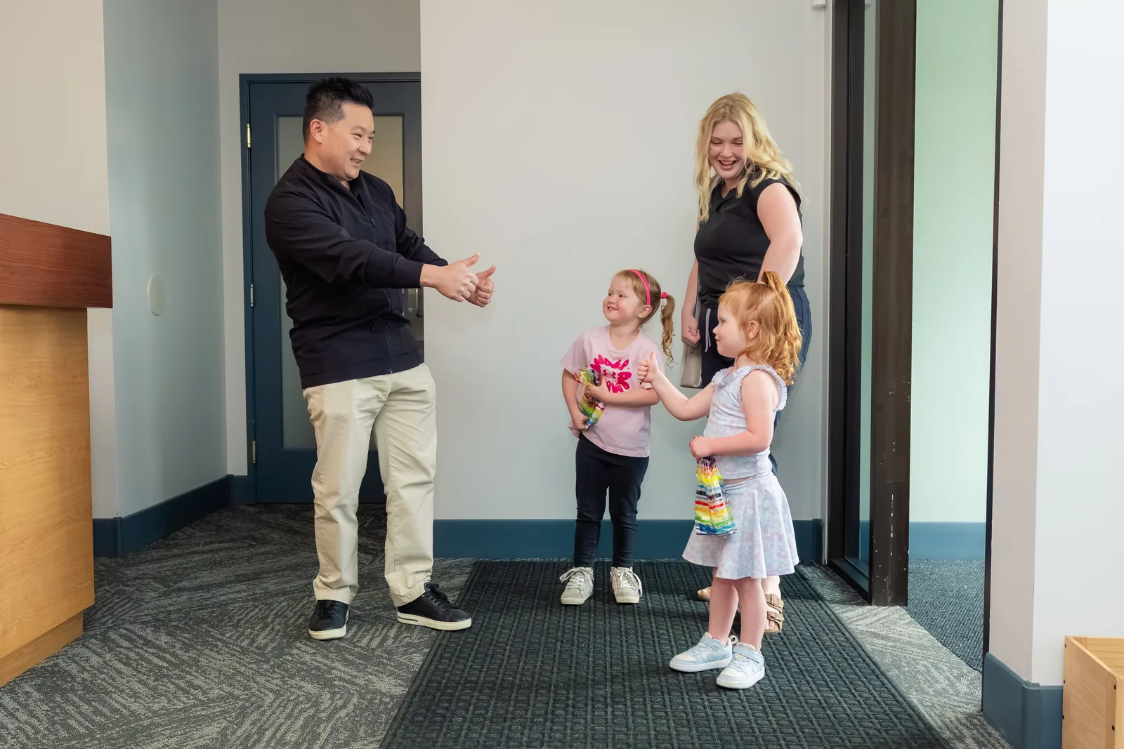 Dr. Kurt Truong welcoming two young patients at Pleasant Valley Pediatric Dentistry in Vancouver, WA