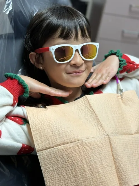 Relaxed young patient reclined in the dental chair